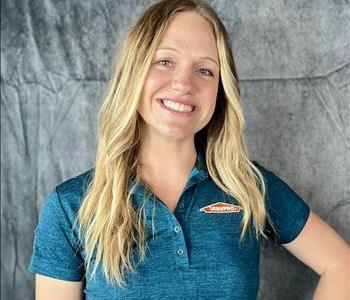 Female standing in front of grey background