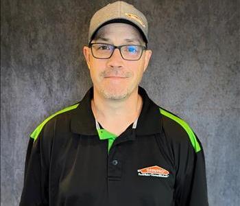 Male employee standing in front of grey backdrop