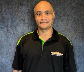 Male employee standing in front of grey backdrop