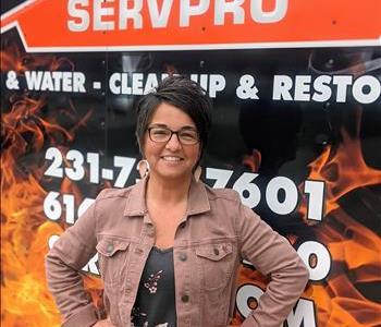 Female standing in front of SERVPRO storm trailer